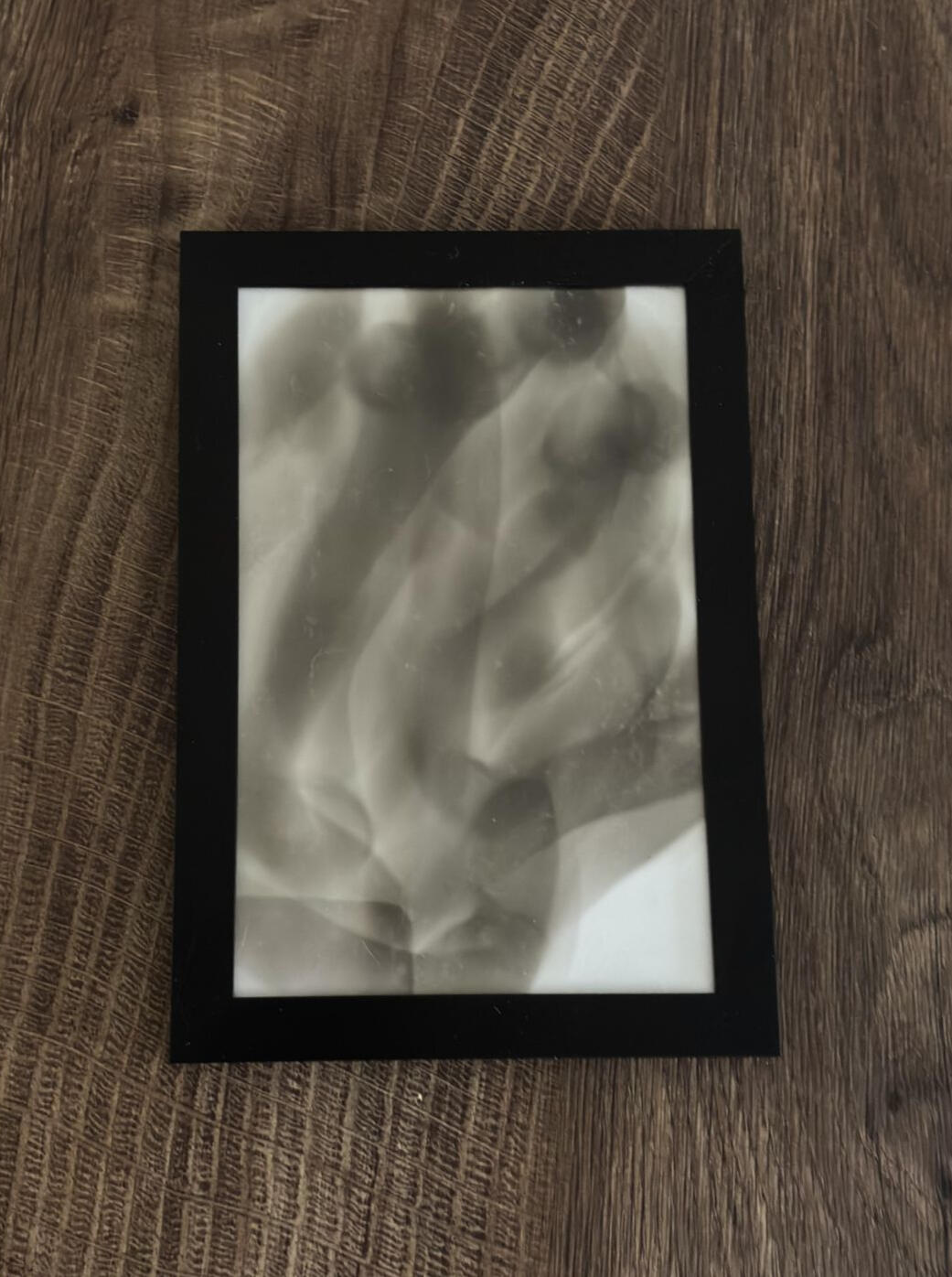 A blank Bristol card held near a candle flame during Diane Stackwick's soot art process.